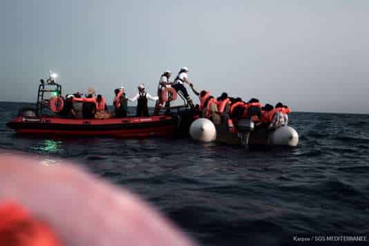 A handout picture taken in the search and rescue zone in the Mediterranean sea on June 9, 2018 and released on June 11, 2018 by SOS Mediterranee NGO shows migrants being rescued before boarding the French NGO's ship Aquarius.